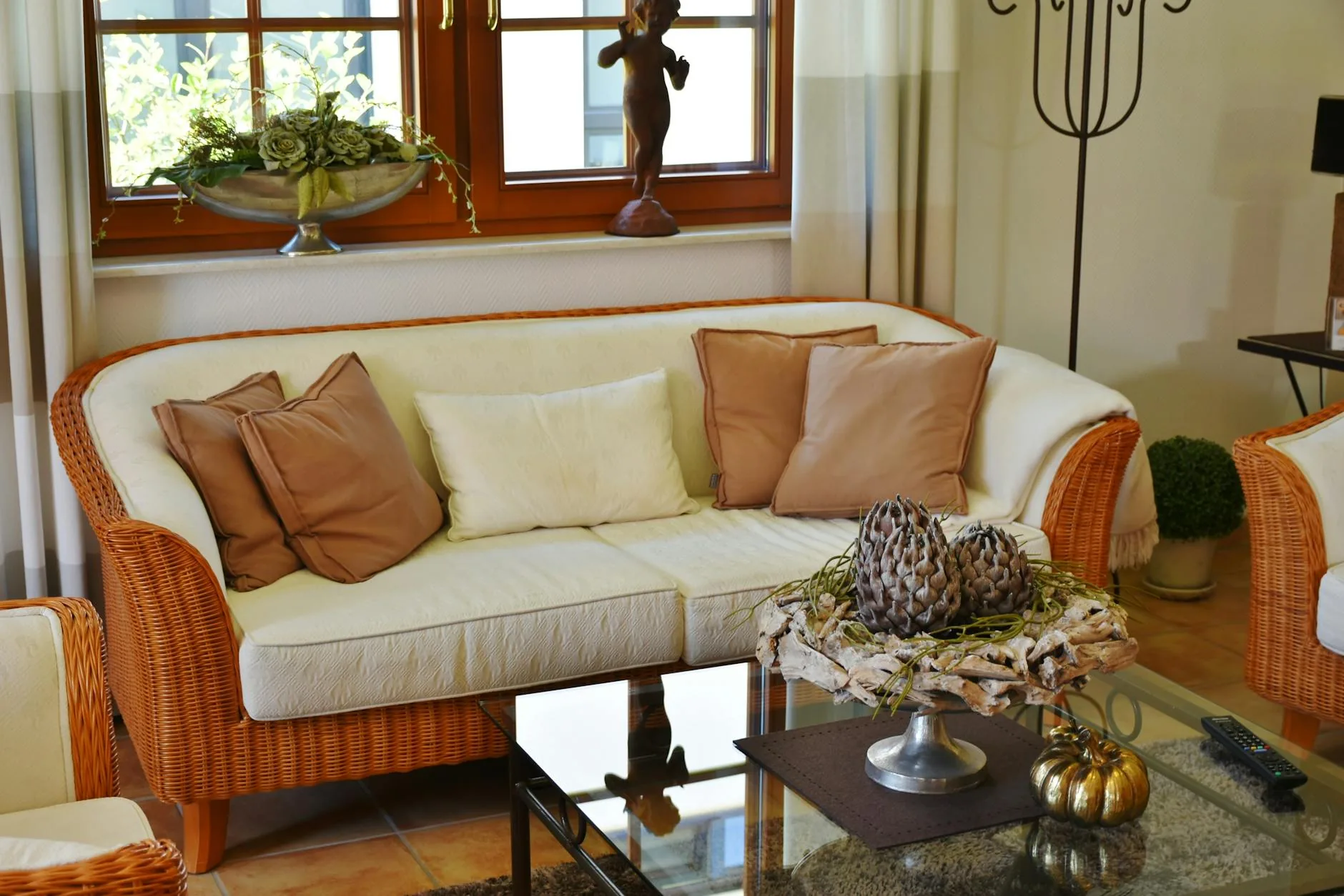 modern editorial living room idea: Earthy Neutrals with cream and warm neutrals with sage green and terracotta accents, designer-curated modern