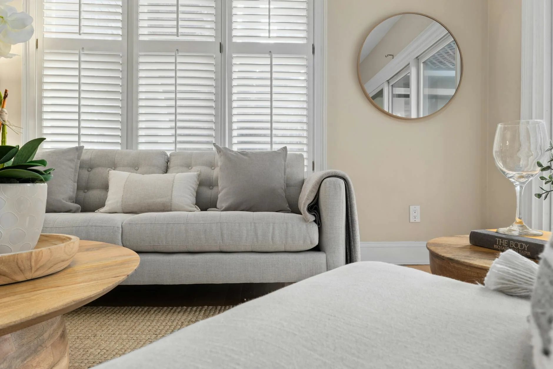 modern editorial living room idea: Luxe Neutrals with cream and warm neutrals with sage green and terracotta accents, designer-curated modern