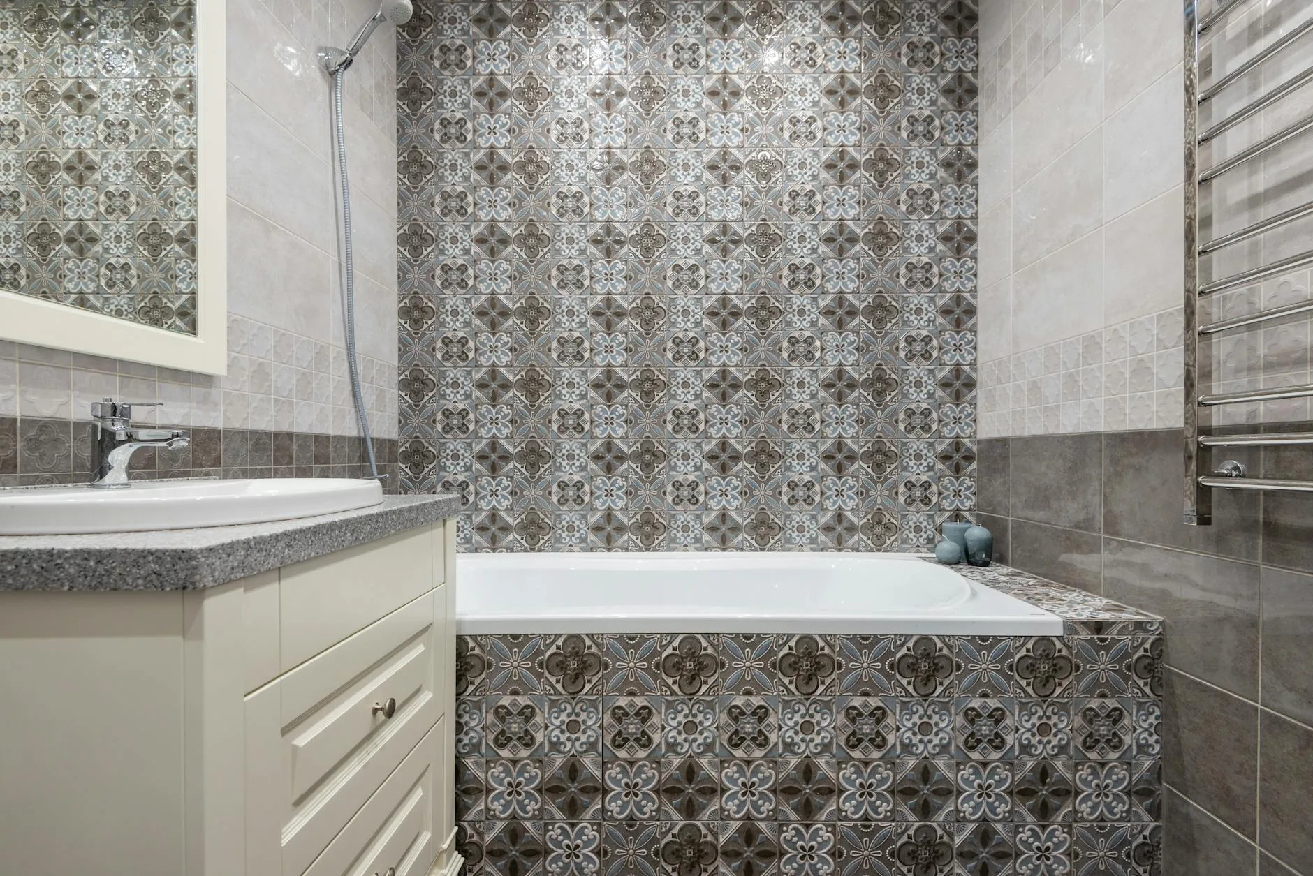 modern editorial bathroom idea: Bold Pattern Play with cream and warm neutrals with sage green and terracotta accents, designer-curated bathroom