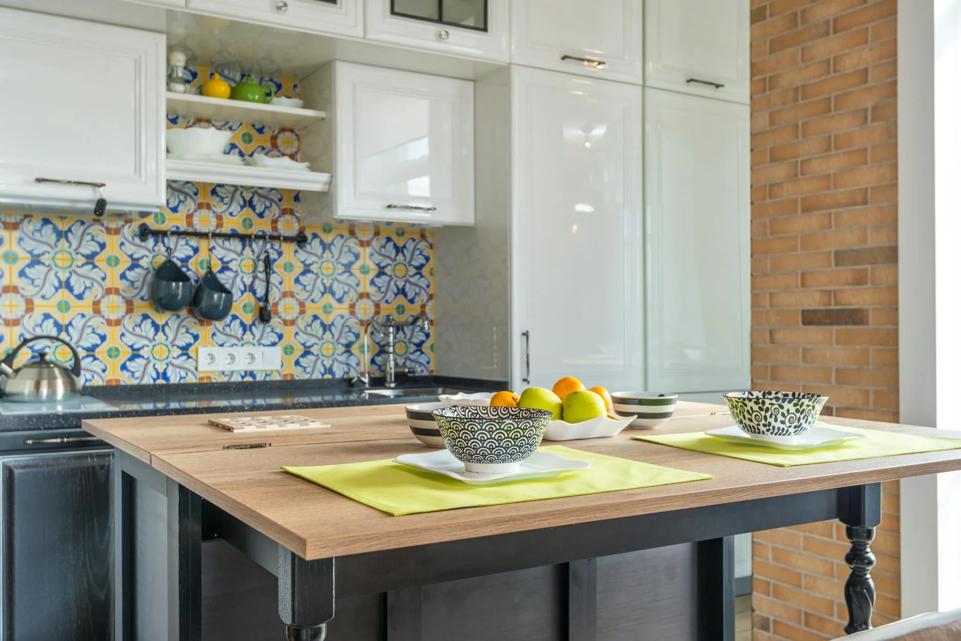modern editorial kitchen idea: Artisanal Tile Patterns with cream and warm neutrals with sage green and terracotta accents, designer-curated modern