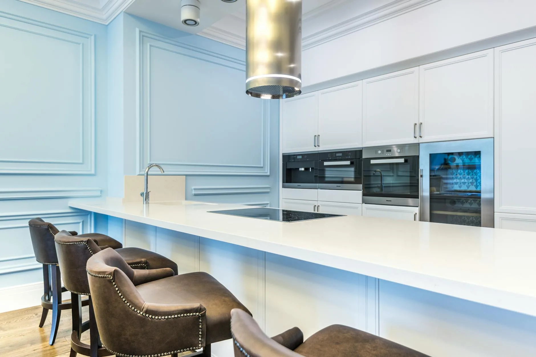 modern editorial kitchen idea: Comparison: Induction vs. Gas Cooktops with cream and warm neutrals with sage green and terracotta accents,