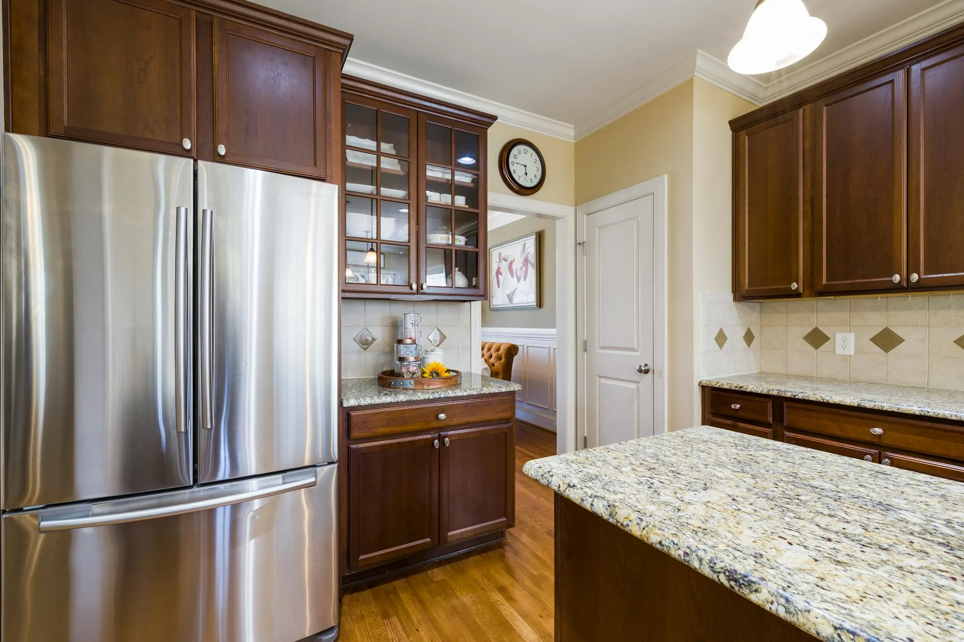 modern editorial kitchen idea: Glass Cabinet Doors with cream and warm neutrals with sage green and terracotta accents, designer-curated modern