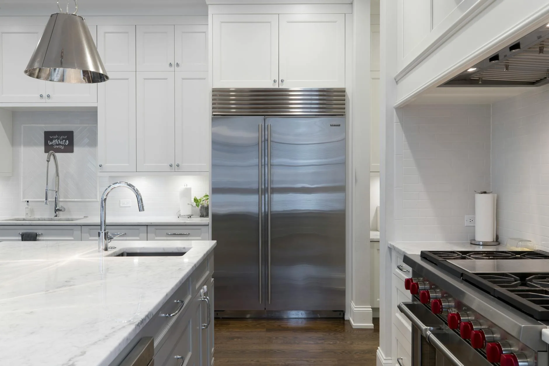 modern editorial kitchen idea: High-Tech Refrigeration with cream and warm neutrals with sage green and terracotta accents, designer-curated modern kitchen