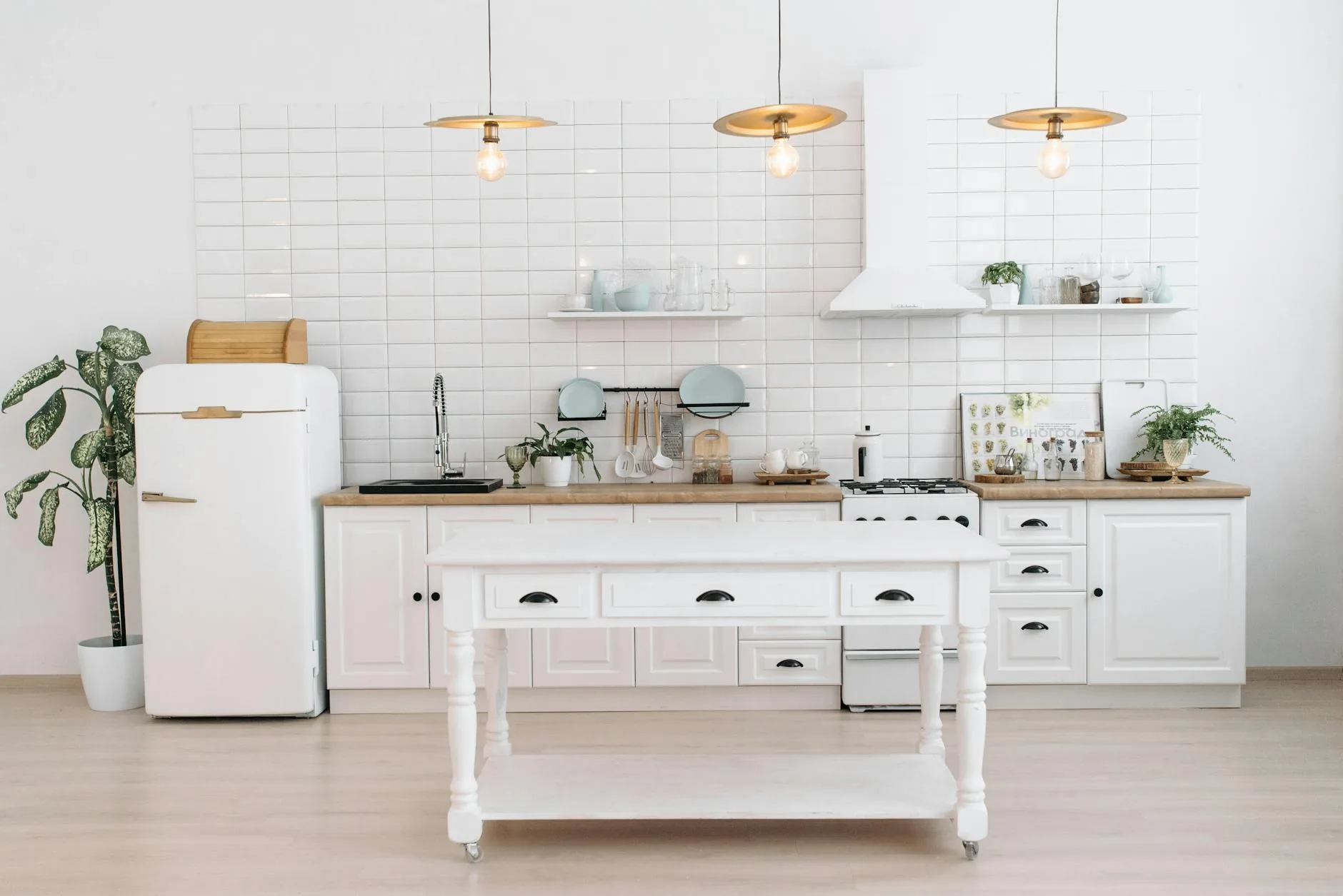 modern editorial kitchen idea: Textured Walls with cream and warm neutrals with sage green and terracotta accents, designer-curated modern kitchen