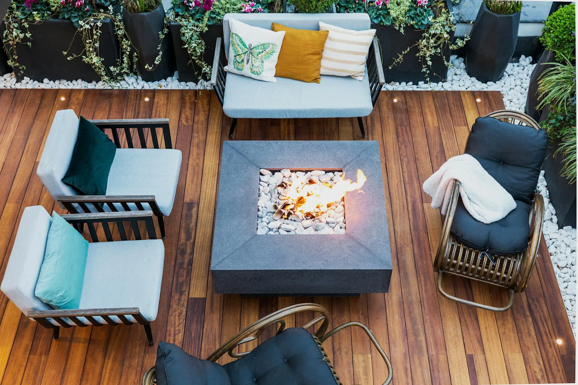 modern editorial outdoor space idea: Cozy Fireplaces with cream and warm neutrals with sage green and terracotta accents, designer-curated outdoor