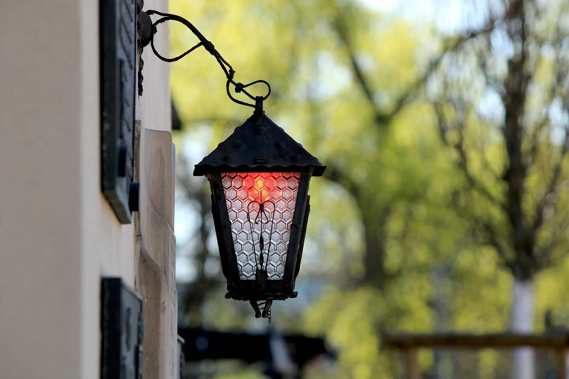 modern editorial outdoor space idea: Hanging Lanterns with cream and warm neutrals with sage green and terracotta accents, designer-curated outdoor
