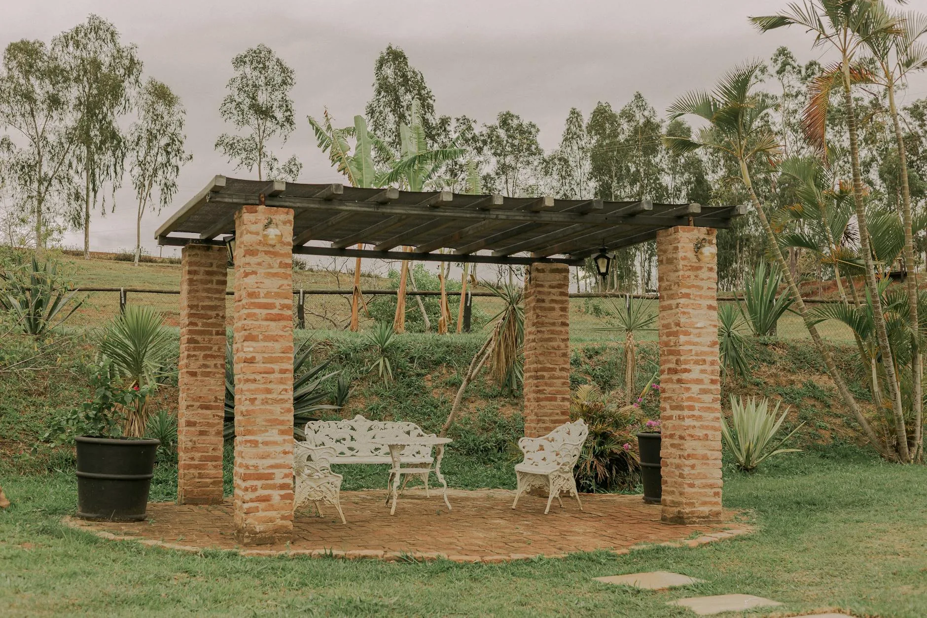 modern editorial outdoor space idea: Pergola with Drapes with cream and warm neutrals with sage green and terracotta accents, designer-curated