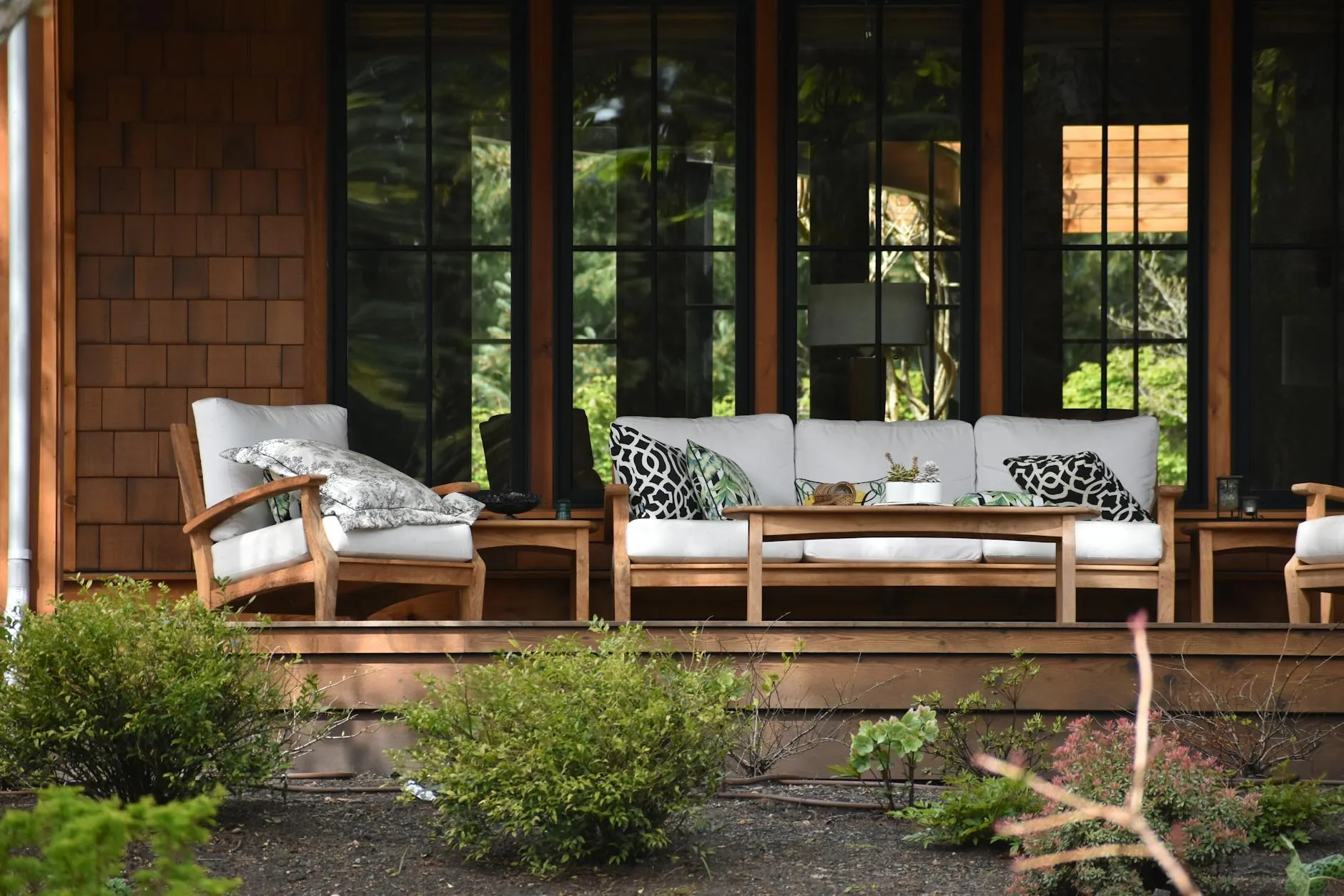 modern editorial outdoor space idea: Sculptural Elements with cream and warm neutrals with sage green and terracotta accents, designer-curated outdoor